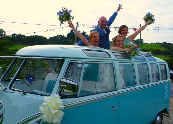 Wedding guests looking out of VW Campervan roof window
