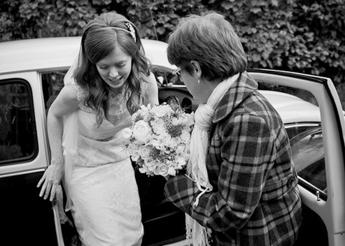 Bride getting out of classic VW Beetle